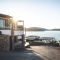Sun Piercing Of Brown Concrete House Near Sea 1732414