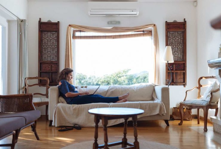 Woman Sitting On Sofa In Living Room 1595589