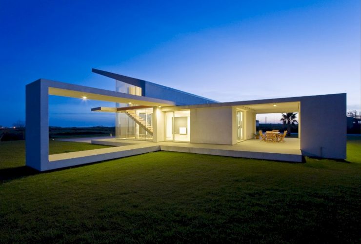 Villa T: A Mediterranean Home with A Solid Facade and White Stucco