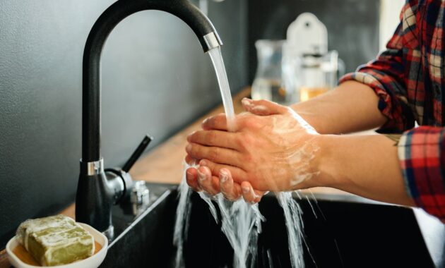 Woman washing hands with soap