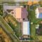 Aerial landscape of small town or village with rows of residential homes and green trees
