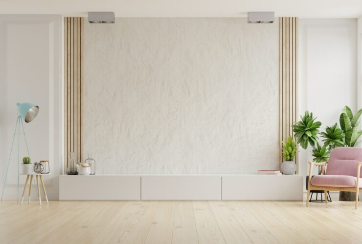 Cabinet for TV on the white plaster wall.