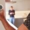 Close Up Of Man Adjusting Wall Mounted Digital Central Heating Thermostat Control At Home
