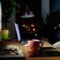 Comfortable workspace for distance job at home - mug of tea, laptop, lamp, tablet, mobile, plant