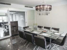 Dining room with modern furniture and chandelier.