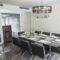 Dining room with modern furniture and chandelier.