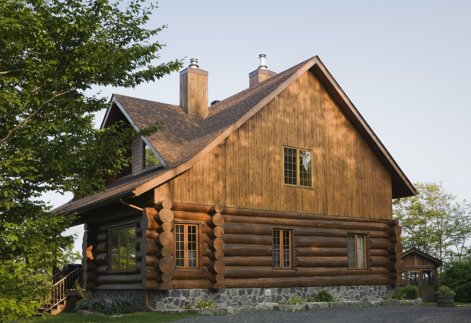 Exterior of cottage style log house with cedar shingles