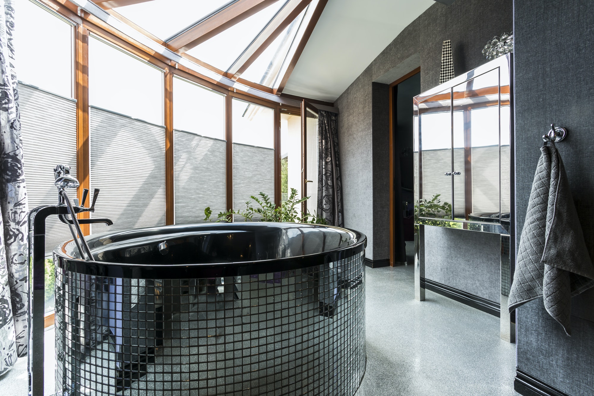 Luxurious bathroom with freestanding glossy bathtub