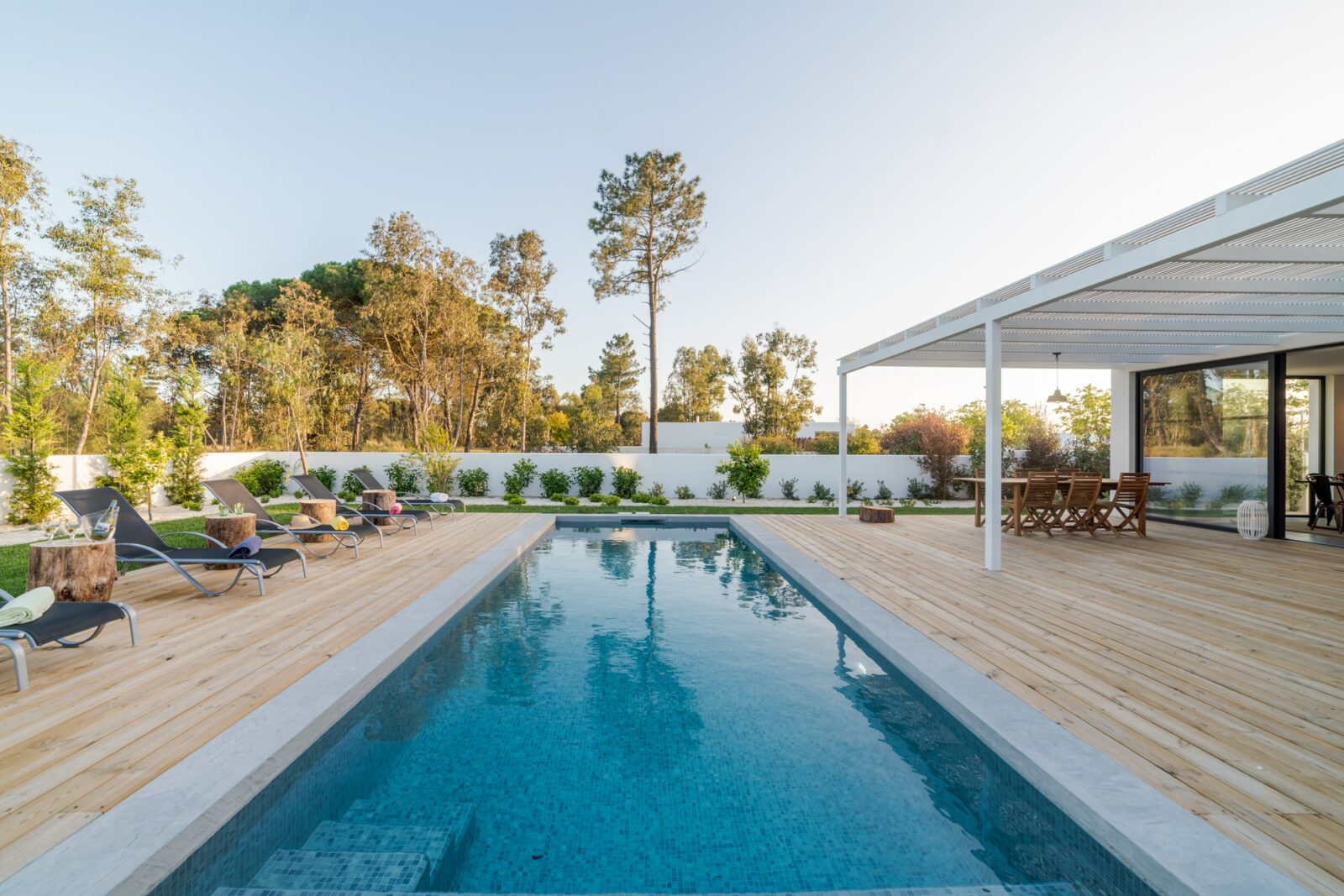 Modern house with garden swimming pool and wooden deck