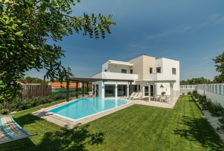 Modern house with garden swimming pool and wooden pergula