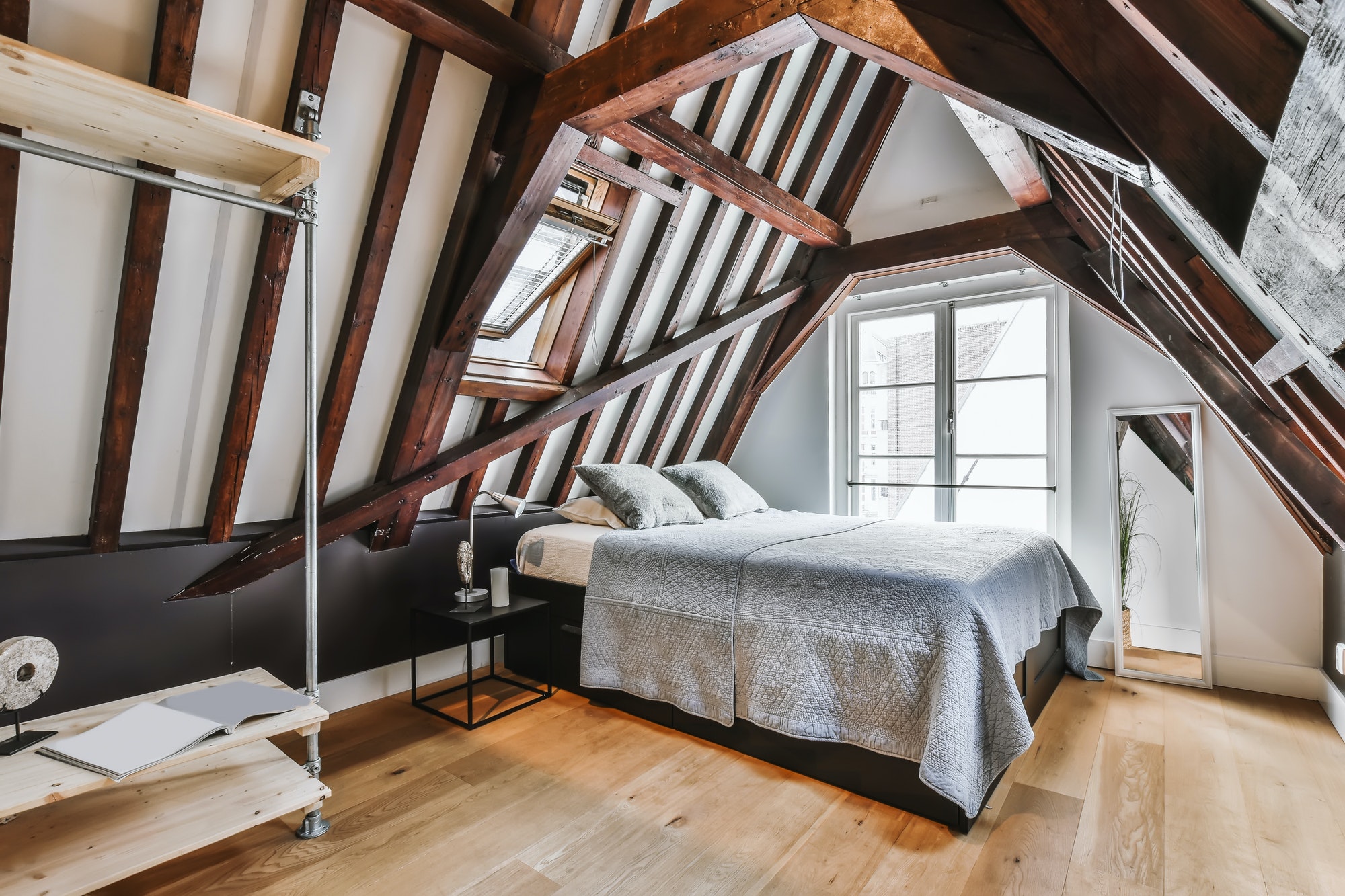 Stylish attic bedroom with a soft bed