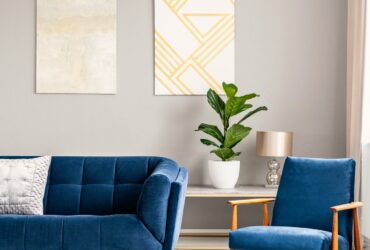 Two modern art paintings hanging on wall in real photo of bright