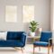Two modern art paintings hanging on wall in real photo of bright