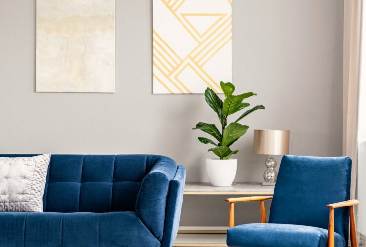 Two modern art paintings hanging on wall in real photo of bright