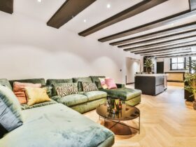 Big soft sofa with cushions in open living room