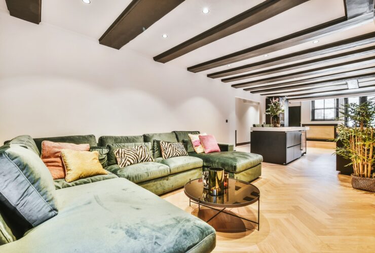 Big soft sofa with cushions in open living room