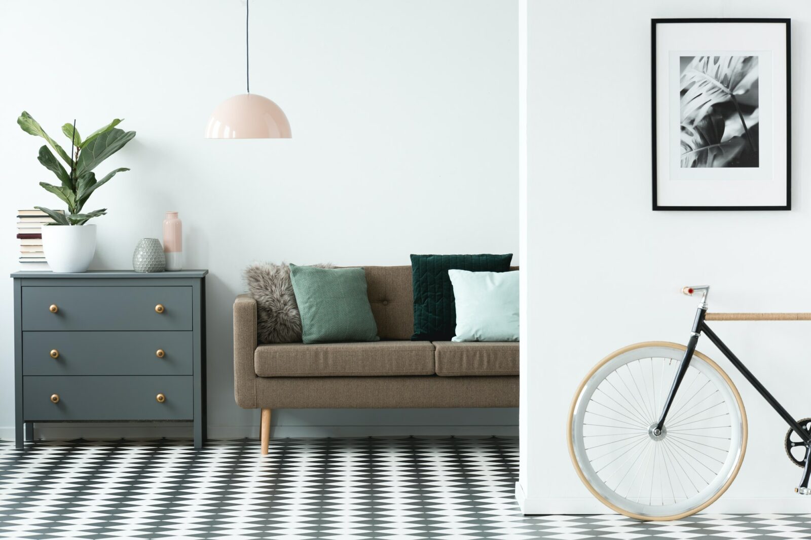Chest of drawers next to a sofa with pillows and patterned floor