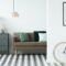 Chest of drawers next to a sofa with pillows and patterned floor