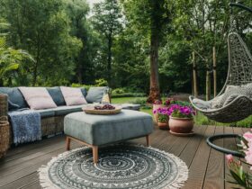Garden patio decorated with Scandinavian wicker sofa and coffee table