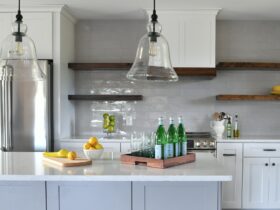 Kitchen in a new home with open concept layout, white counters cabinets floating wood shelves