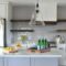 Kitchen in a new home with open concept layout, white counters cabinets floating wood shelves