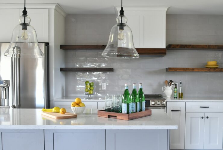 Kitchen in a new home with open concept layout, white counters cabinets floating wood shelves