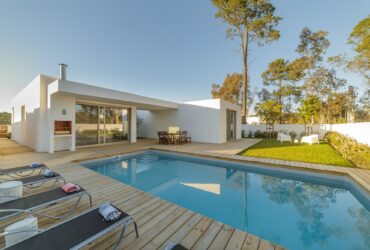 Modern house with garden swimming pool and wooden deck