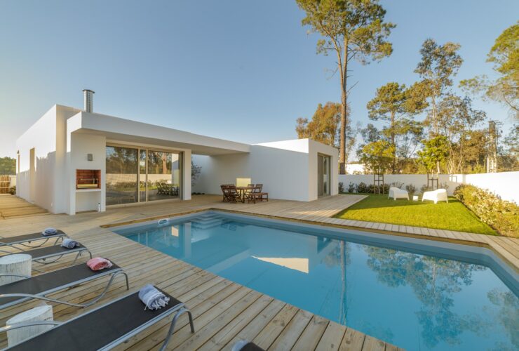 Modern house with garden swimming pool and wooden deck