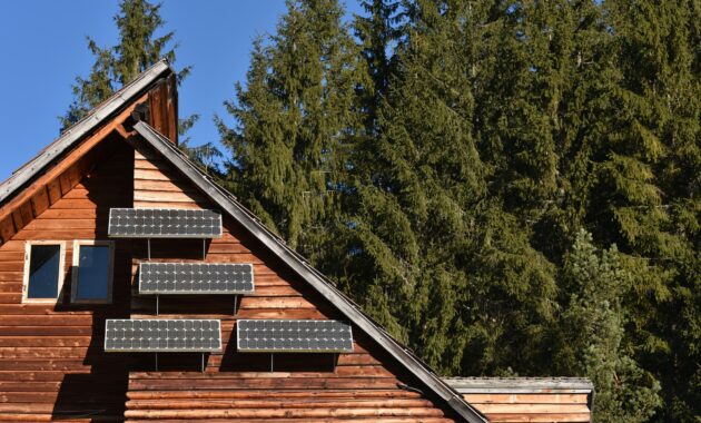 Solar panel on a wooden cottage in the forest
