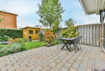 The backyard of a house with a summer dining room