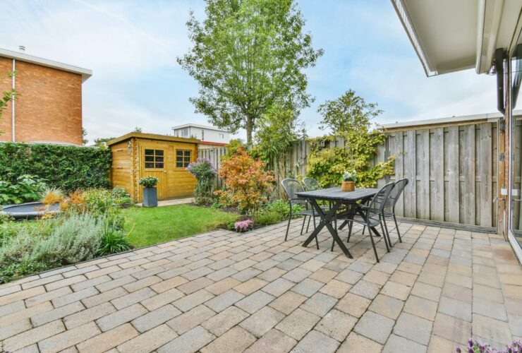 The backyard of a house with a summer dining room