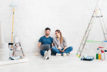Young couple using laptop during home improvement