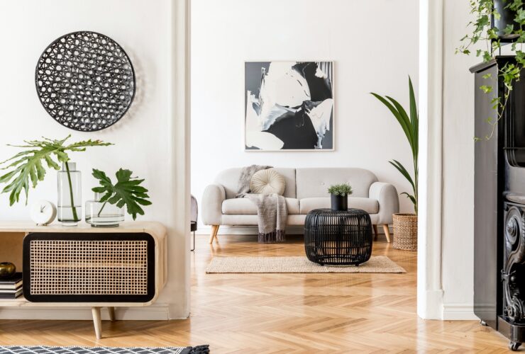 Creative modern home interior with painting, sofa, rattan commode.