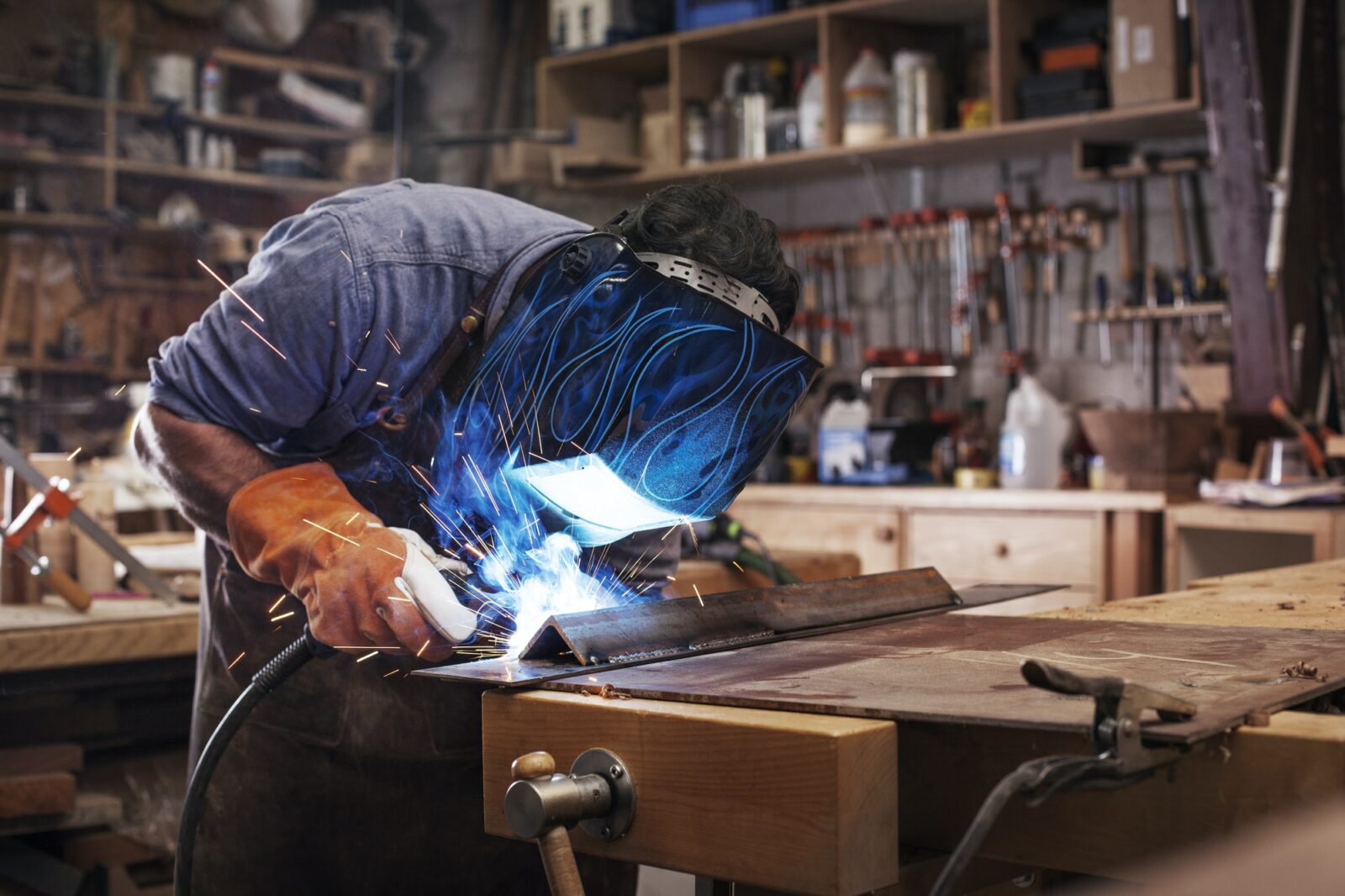 Manual Worker Welding Metal At Workshop