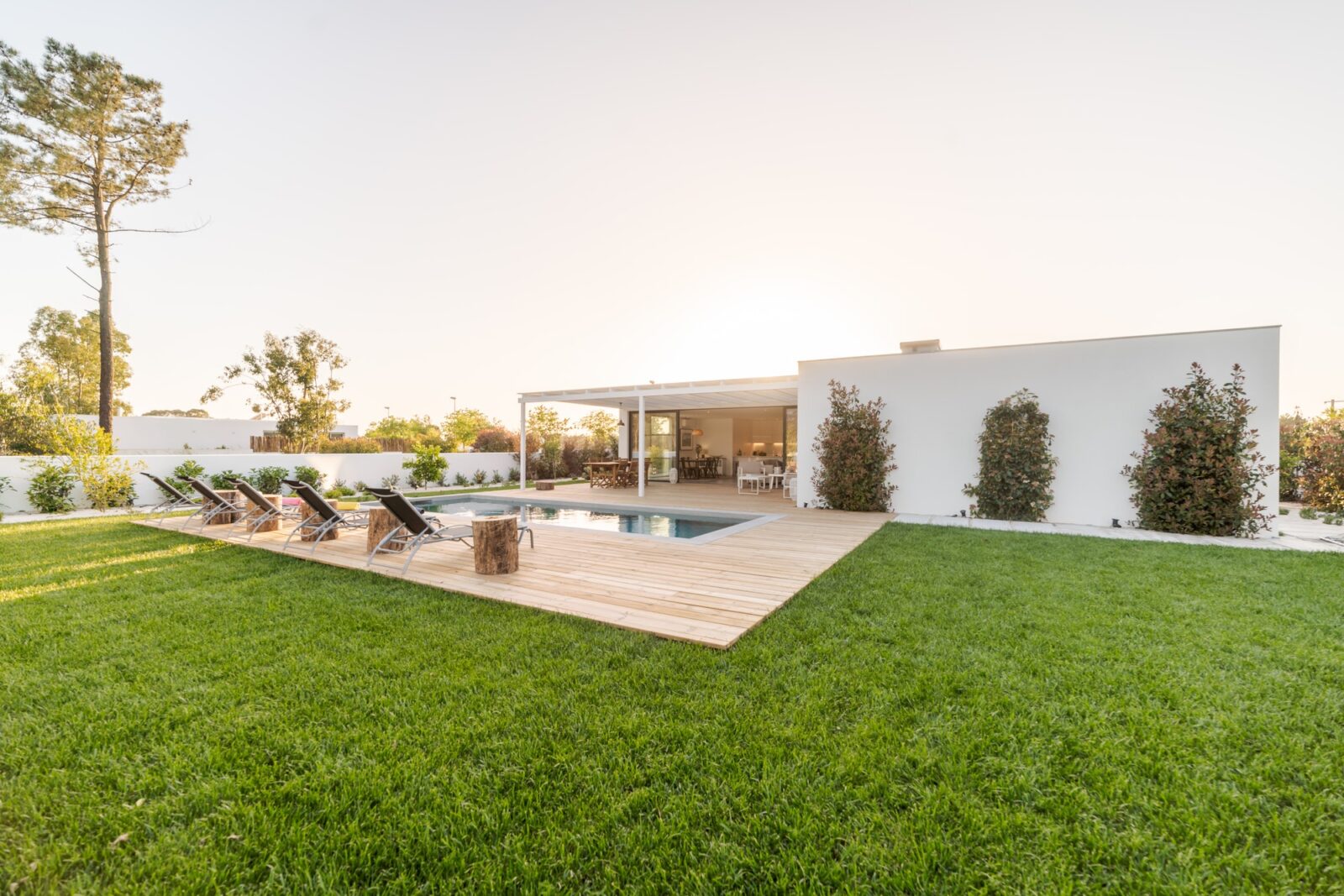 Modern house with garden swimming pool and wooden deck