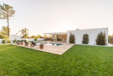 Modern house with garden swimming pool and wooden deck