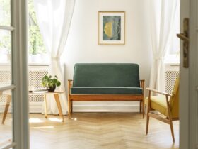 Real photo of a vintage living room interior with a green sofa,