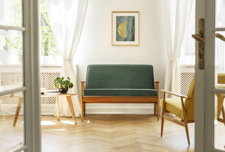 Real photo of a vintage living room interior with a green sofa,