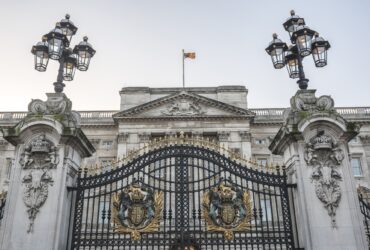 Royal Coat of Arms and the gates at Buckingham Palace, London, England