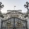 Royal Coat of Arms and the gates at Buckingham Palace, London, England