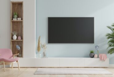 Smart TV on the blue wall in living room.