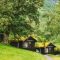 Traditional Norwegian Old Wooden Houses With Growing Grass On Roof. Cabins In Norway
