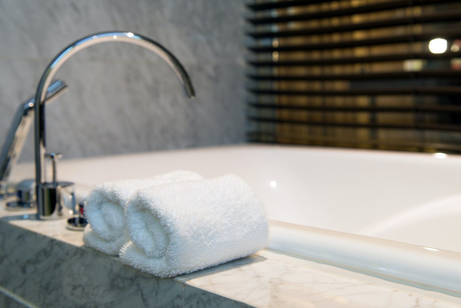 Bathroom towel on a white marble bathtub