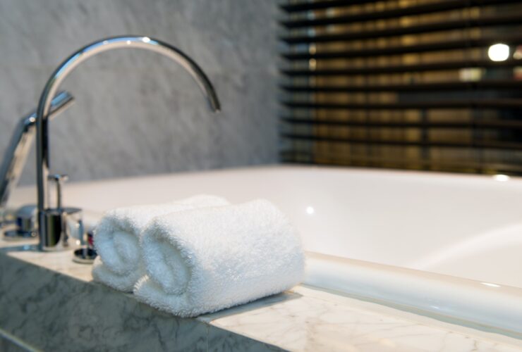 Bathroom towel on a white marble bathtub