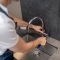 Male hands with spanner repairing water faucet