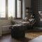 Man sitting in living room in armchair holding mirror ball listening to music