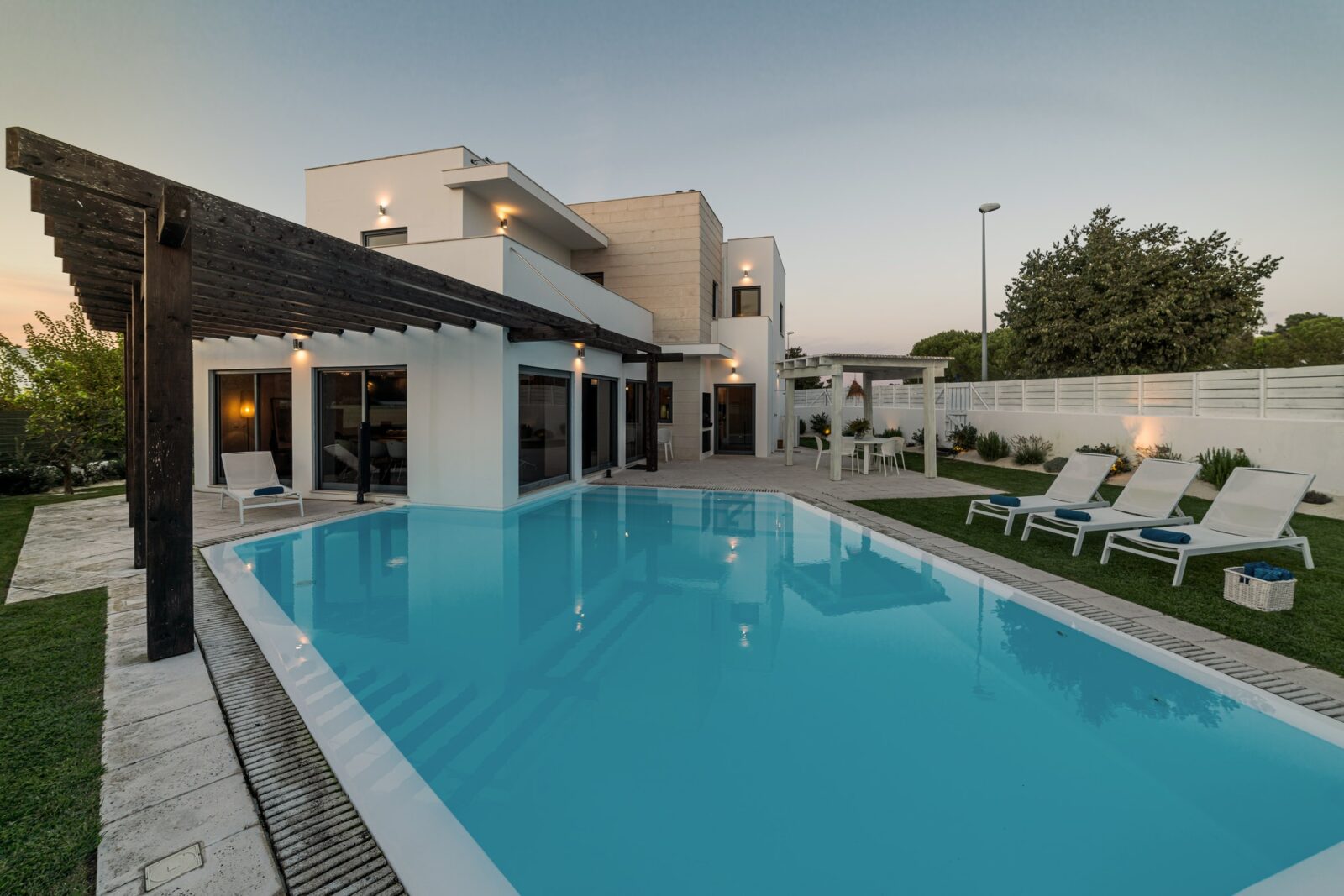 Modern house with garden swimming pool and wooden pergula