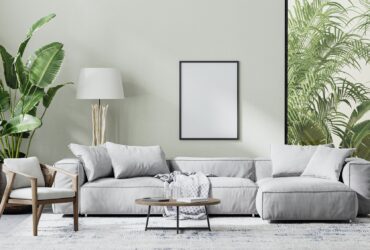 poster frame mock up in modern living room interior with gray sofa, wooden furniture