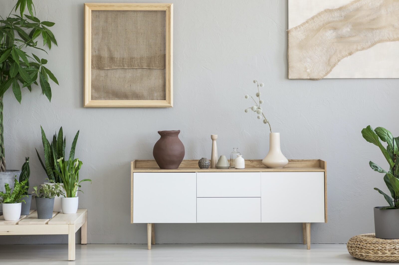 Real photo of a botanic living room interior with burlap artwork