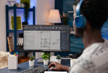 African american architect worker sitting at desk in living room